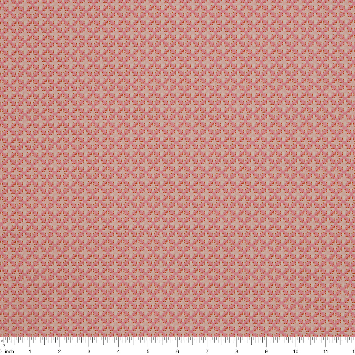 Island Life Summer Rattan fabric with a small woven-inspired geometric pattern in pink and coral with ruler for scale.
