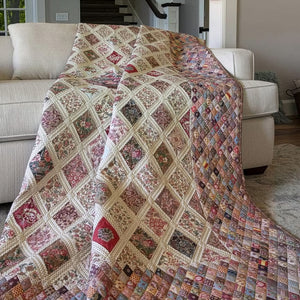 A large patchwork quilted throw blanket draped over a cream-colored sofa in a living room setting.