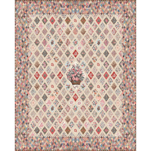 A vintage-style patchwork diamond-patterned rug with a central floral basket motif, featuring a mix of muted pink, blue, beige, and brown tones.