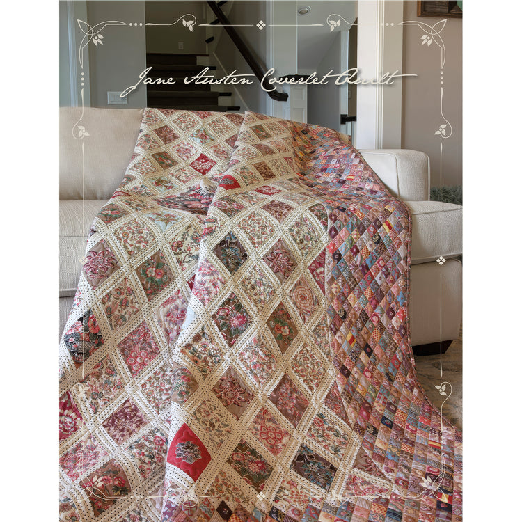 A multicolor patchwork quilt with diamond lattice patterns draped over a light beige sofa in a home setting. The quilt features various floral and geometric patch designs in red, pink, blue, green, and cream.