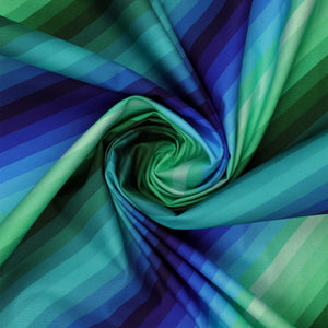 Blue & Green Rainbow Diagonal Stripe fabric draped in a spiral, showcasing vibrant blue, aqua, teal, and green stripes.