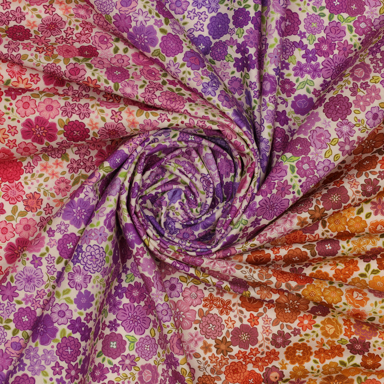 Berry Boho Blooms Ombre fabric draped in a spiral with pink, purple, and orange floral patterns.