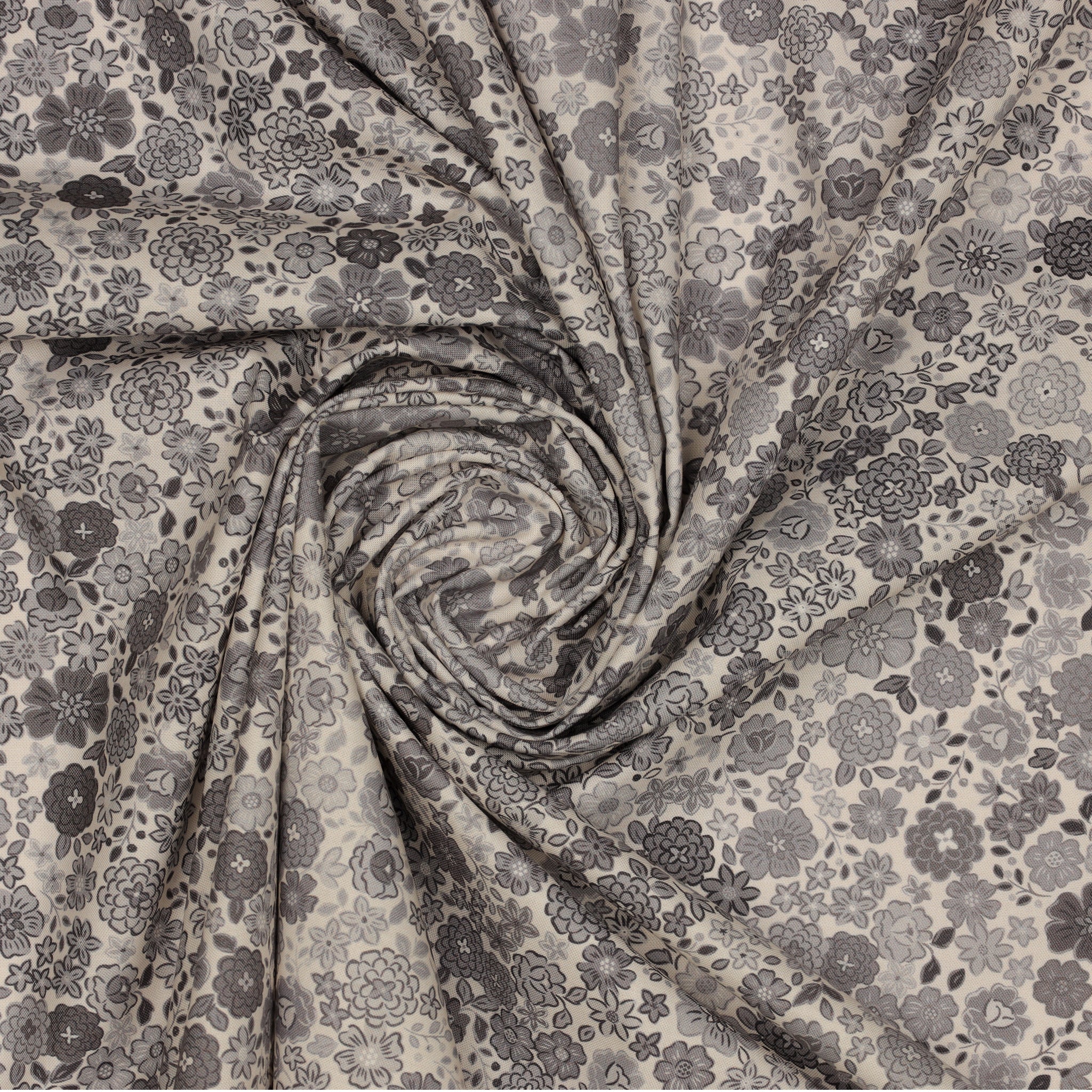Gray floral fabric with assorted blossoms and leaves, gathered into a spiral.