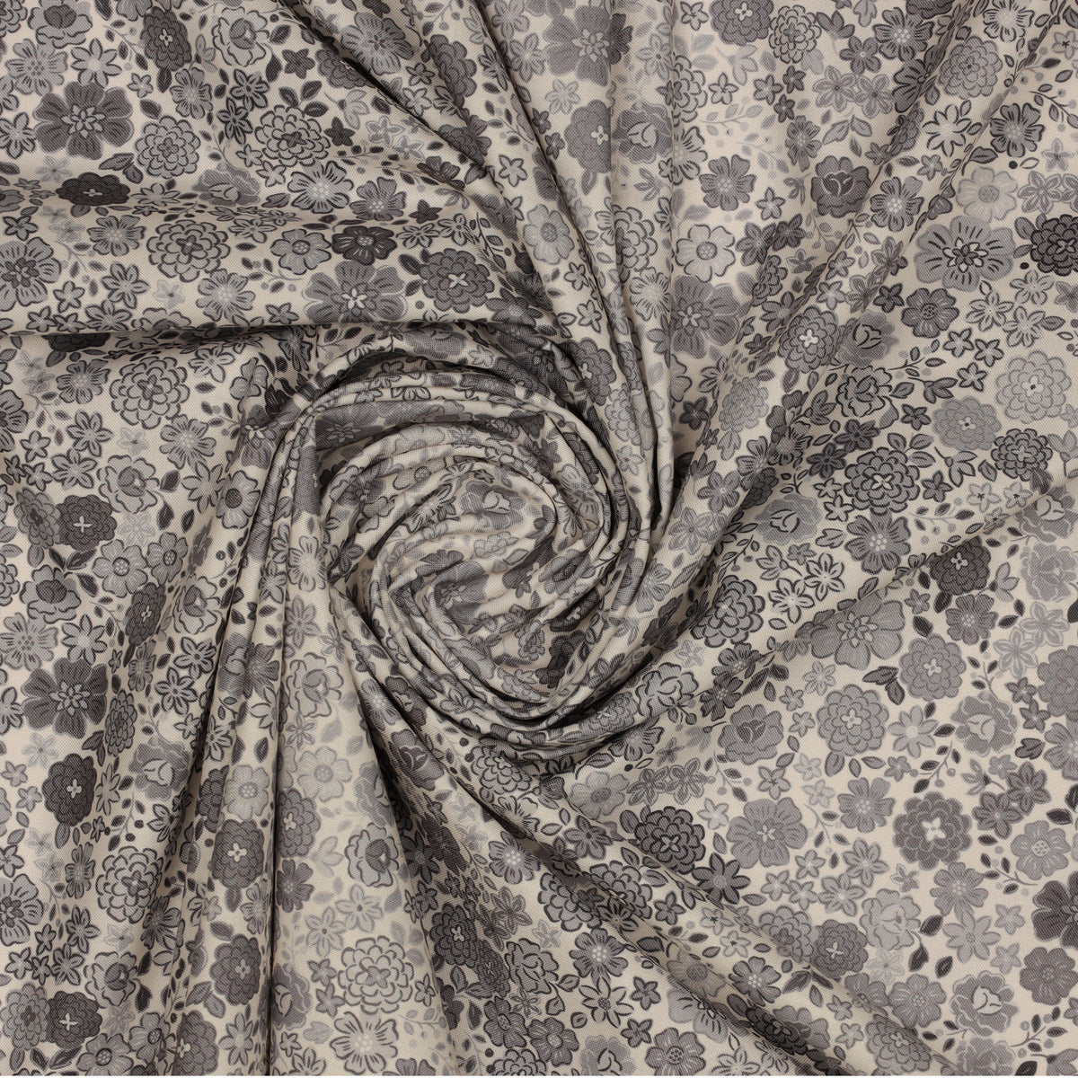 Gray floral fabric with assorted blossoms and leaves, gathered into a spiral.