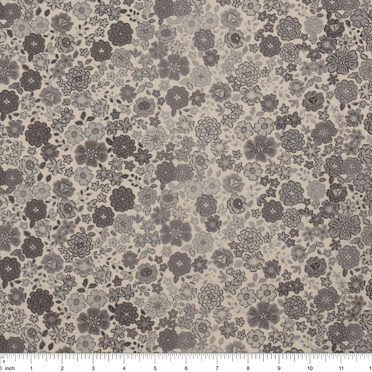 Gray floral fabric with densely scattered flowers in charcoal, taupe, and light gray, shown with a ruler.