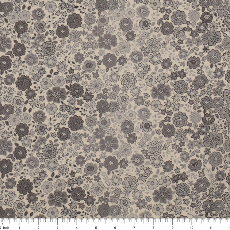 Gray floral fabric with densely scattered flowers in charcoal, taupe, and light gray, shown with a ruler.