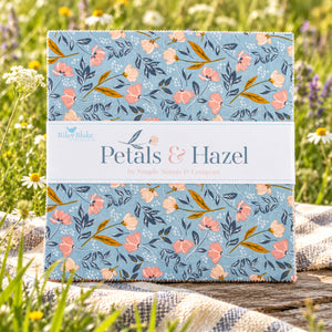 Petals & Hazel 42-piece 10-inch Stacker with a blue floral print and white paper label laid outside in the grass.
