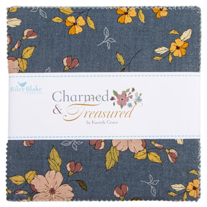 A fabric bundle wrapped with a white band showing a blue-gray floral print with yellow, peach, and muted pink flowers and leaves.