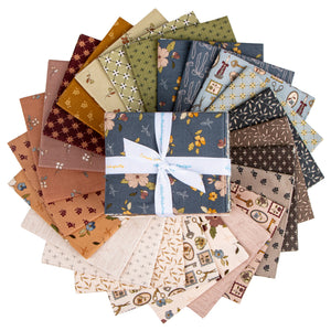 A bundle of fabric squares arranged in a circular fan, with a central folded square tied in a white ribbon.