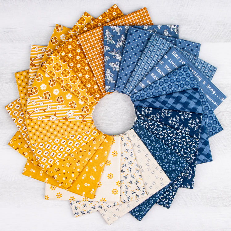 A circular arrangement of patterned fabric swatches in yellow, orange, blue, and cream on a white textured background.