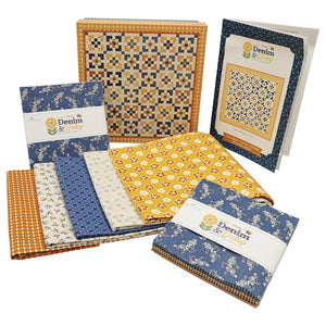 A collection of fabric bundles, pattern, and keepsake box. The fabrics vary in color from blue, yellow and white.