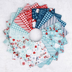 A Perfect Winter fabric assortment featuring festive snowmen, snowflakes, mittens, winter florals, holiday lettering, gingham checks, and stripes in icy blue, navy, red, and white, arranged in a circular fan.