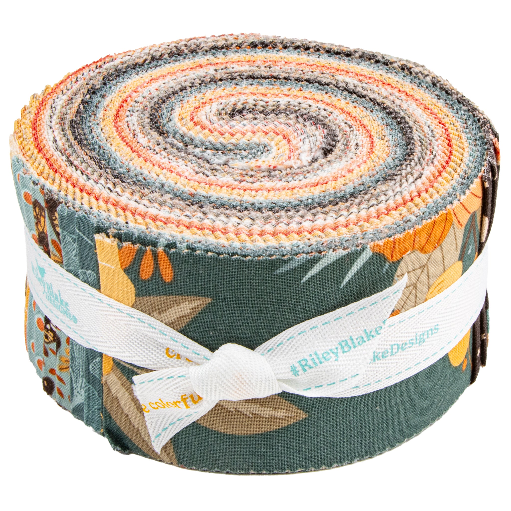 A rolled fabric bundle with a multicolor patterned design featuring orange, yellow, gray, and blue tones, wrapped with a white ribbon printed with the brand name Riley Blake Designs.