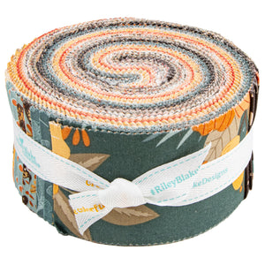 A rolled fabric bundle with a multicolor patterned design featuring orange, yellow, gray, and blue tones, wrapped with a white ribbon printed with the brand name Riley Blake Designs.