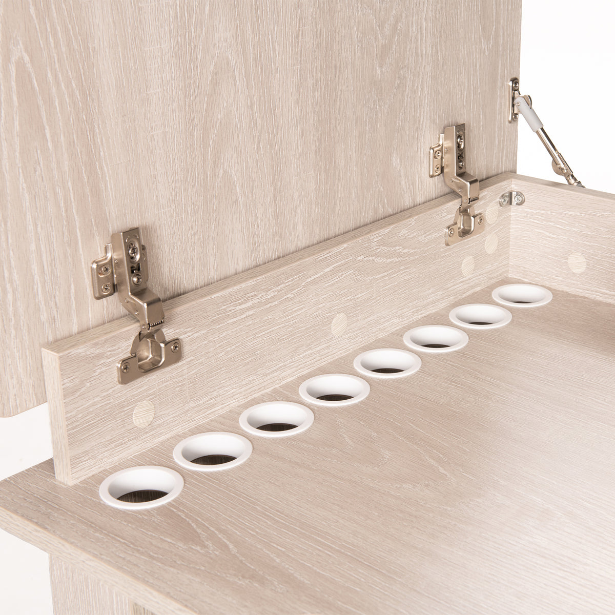 Close-up of Koala Serger Studio cabinet showing thread spool holes and soft-close hinge hardware