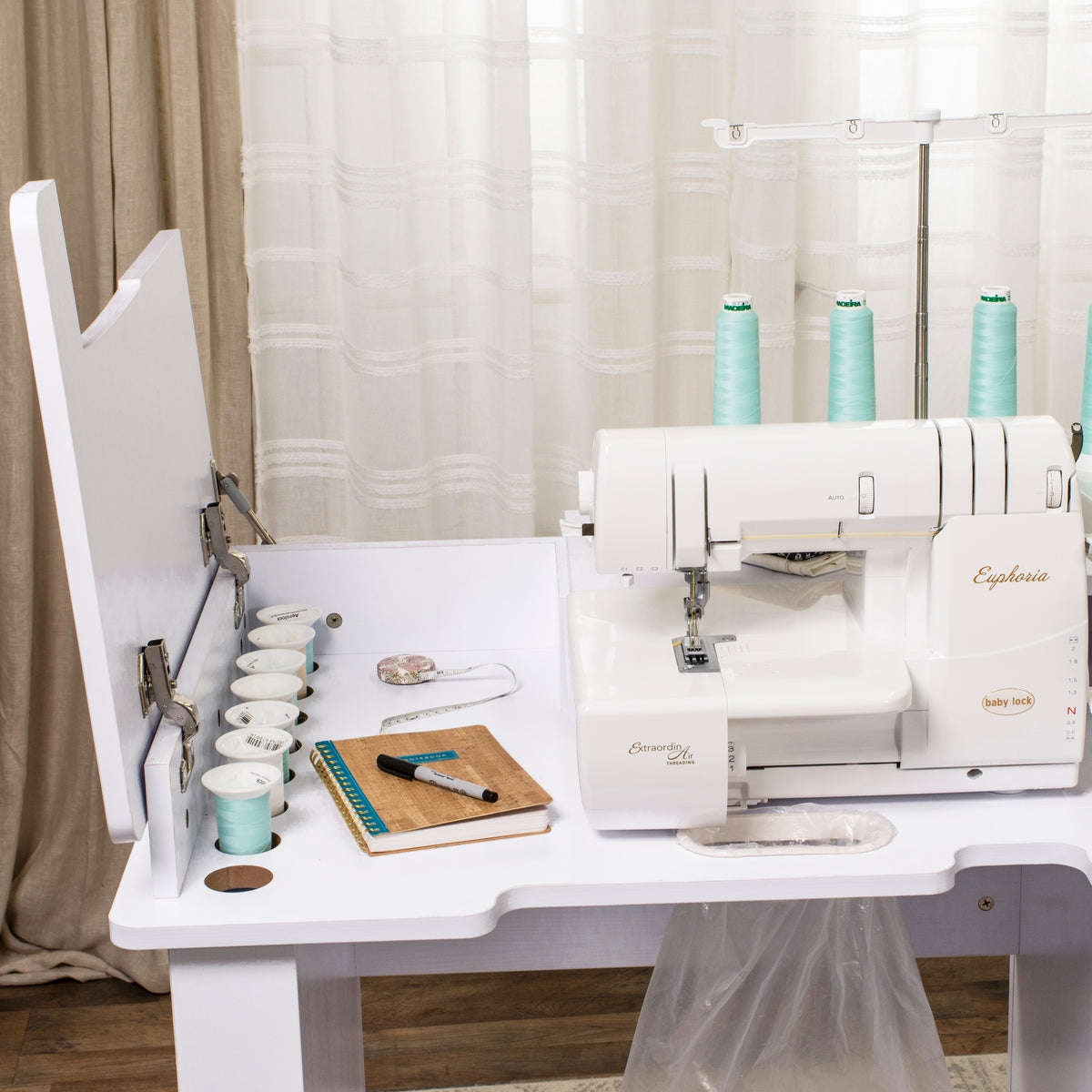 Koala Serger Studio cabinet in use with serger machine, thread spools and storage cubbies open