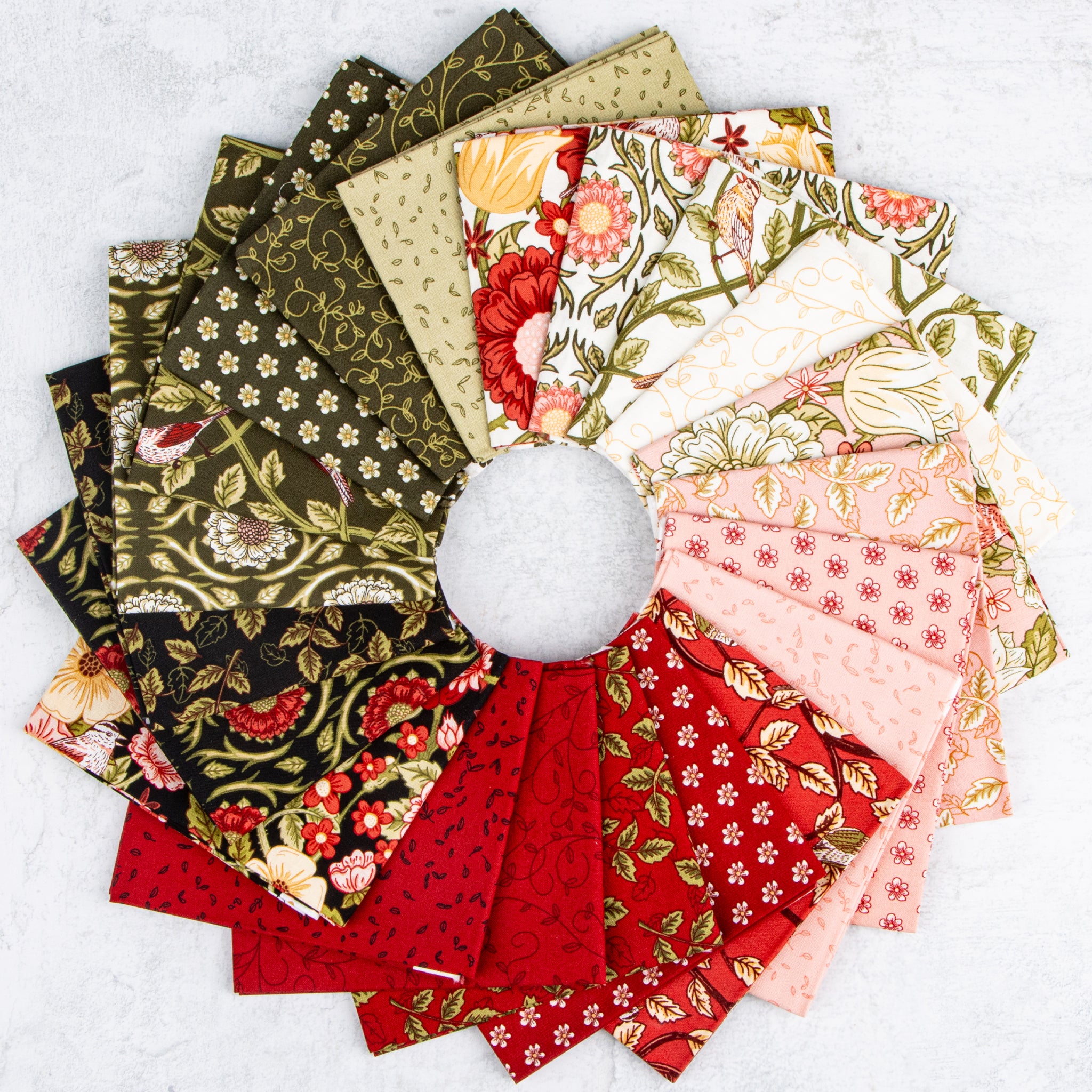 Tangled Garden fabrics with floral, bird, vine, and leaf prints in red, pink, cream, and green.