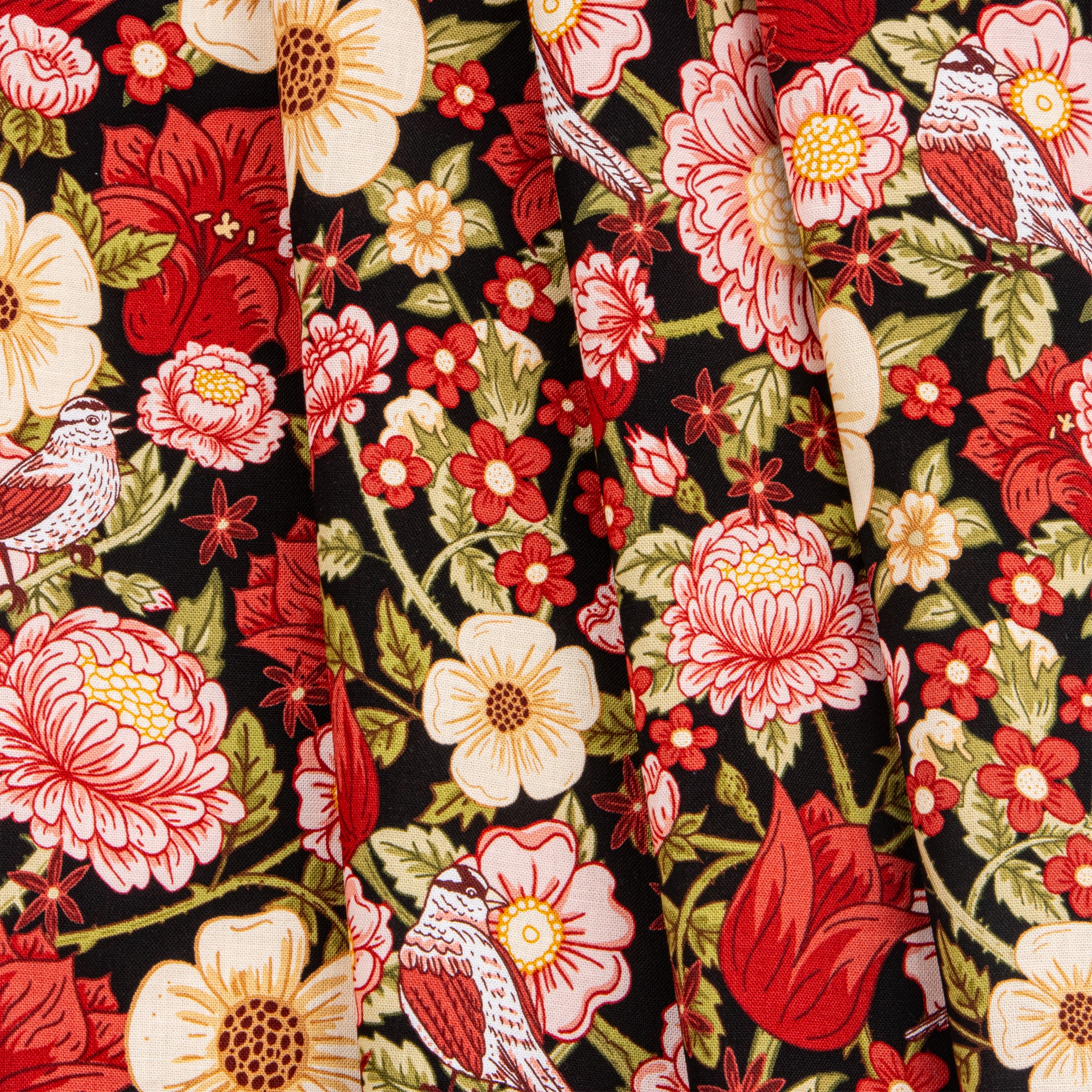 Black fabric with red, pink, and cream flowers, green leaves, and small birds.