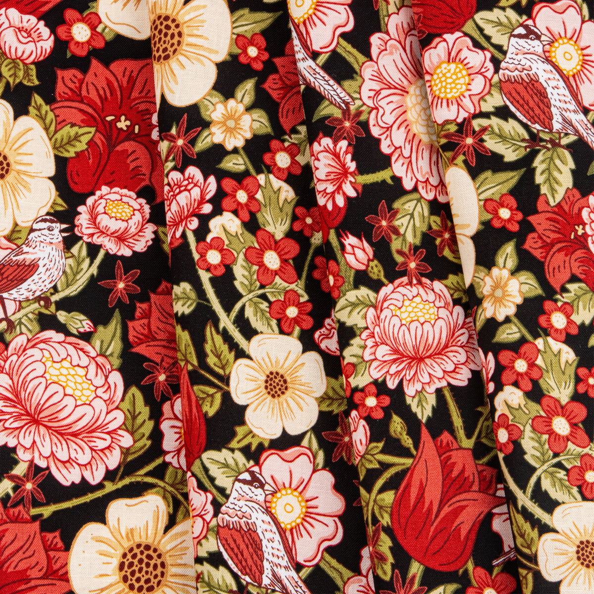Black fabric with red, pink, and cream flowers, green leaves, and small birds.