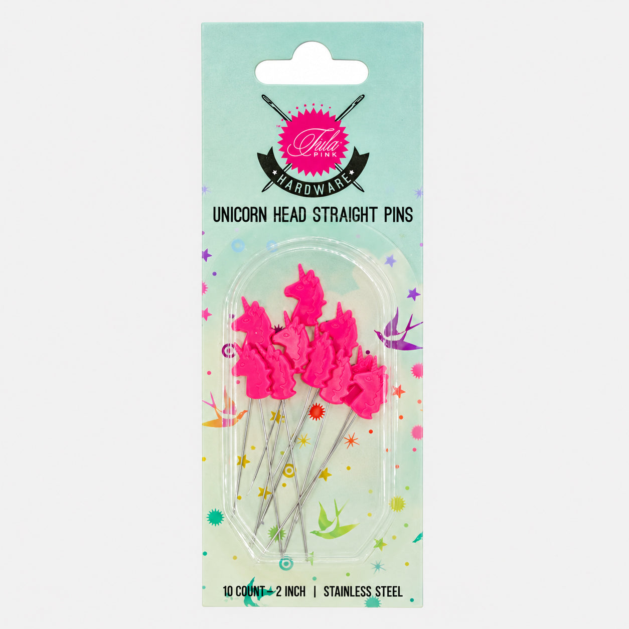 Pack of 10 unicorn head straight pins in bright pink, packaged on a mint green card with unicorn illustrations. The card shows the brand 'Pebble House' and product name 'UNICORN HEAD STRAIGHT PINS'.