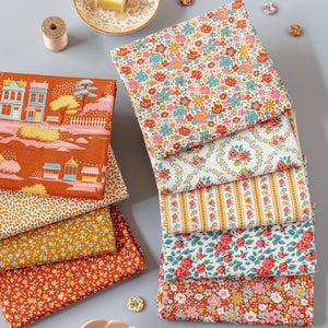 Folded Village Life fabrics in warm rust, teal and cream floral and village prints.