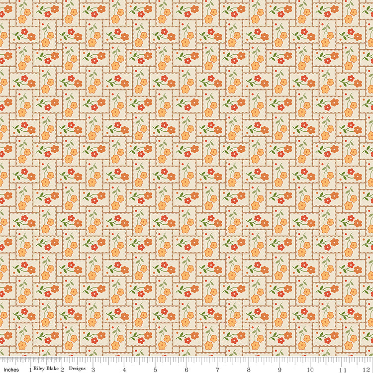 Small orange flowers with green leaves on a patchwork pattern with a ruler along the bottom for scale. 