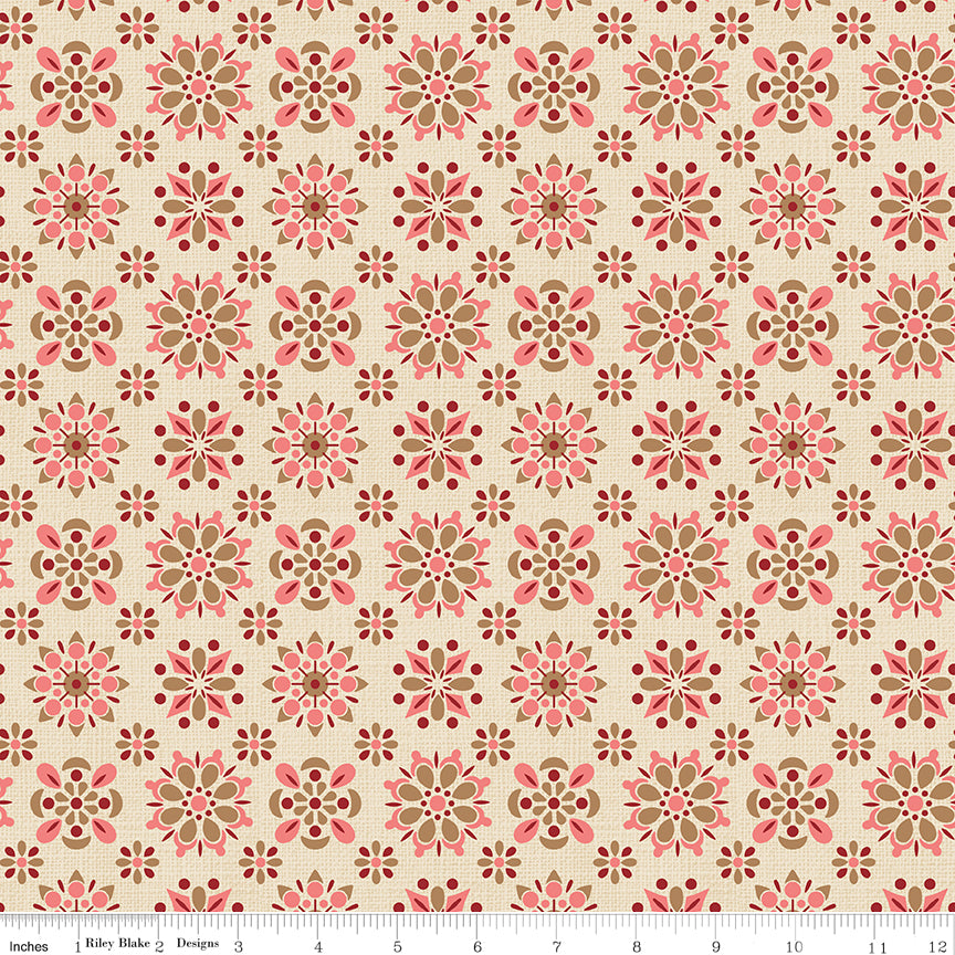 Patterned fabric with pink and brown flowers on a beige background with a ruler along the bottom for scale. 