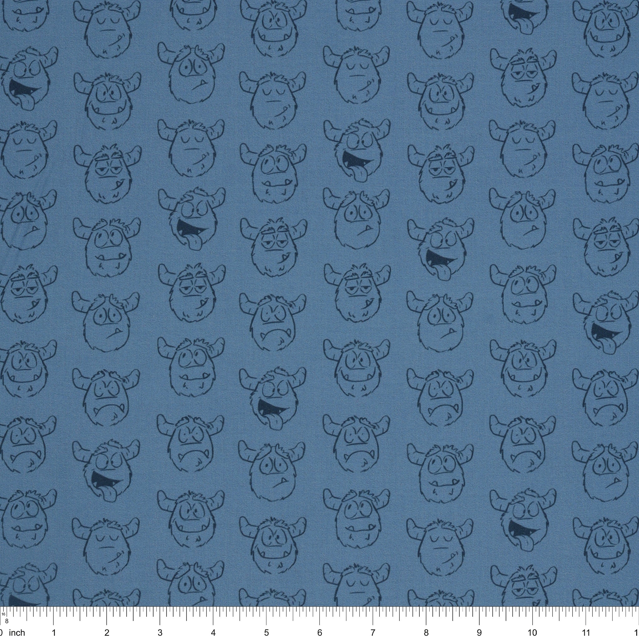 Yeti-tude Blue fabric with rows of expressive yeti faces outlined in navy on a muted blue background with ruler for scale.