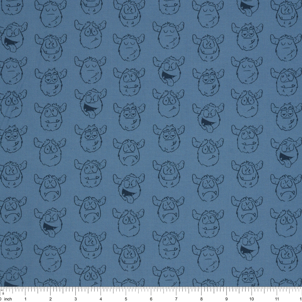Yeti-tude Blue fabric with rows of expressive yeti faces outlined in navy on a muted blue background with ruler for scale.