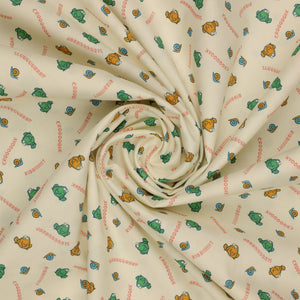 Toadally Chatty Cream fabric with green and yellow frogs, tiny snails, and coral sound words arranged in a swirl.