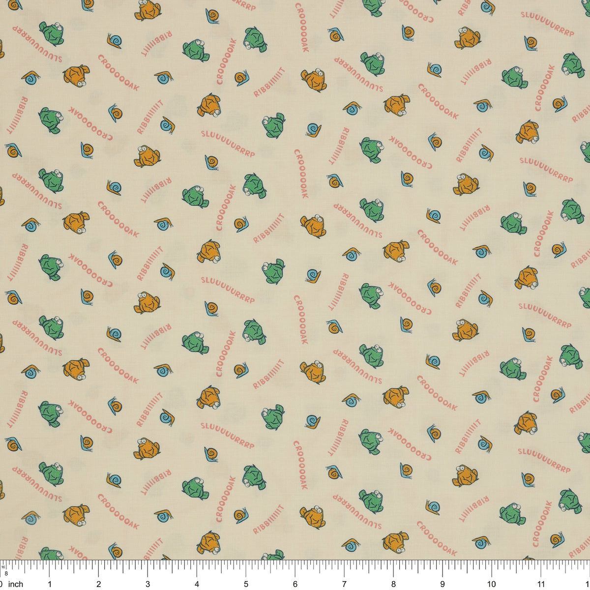 Toadally Chatty Cream fabric with green and yellow frogs, tiny snails, and coral sound words with ruler for scale.