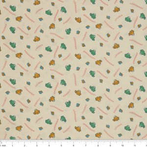 Toadally Chatty Cream fabric with green and yellow frogs, tiny snails, and coral sound words with ruler for scale.
